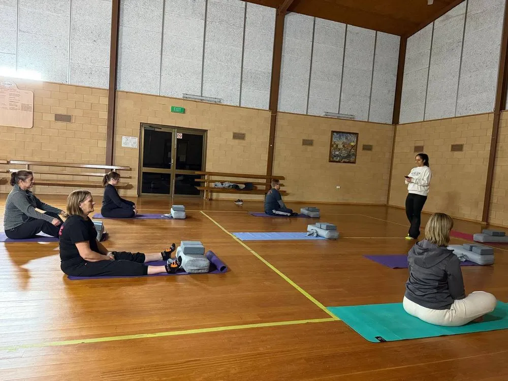A seated yin class in session